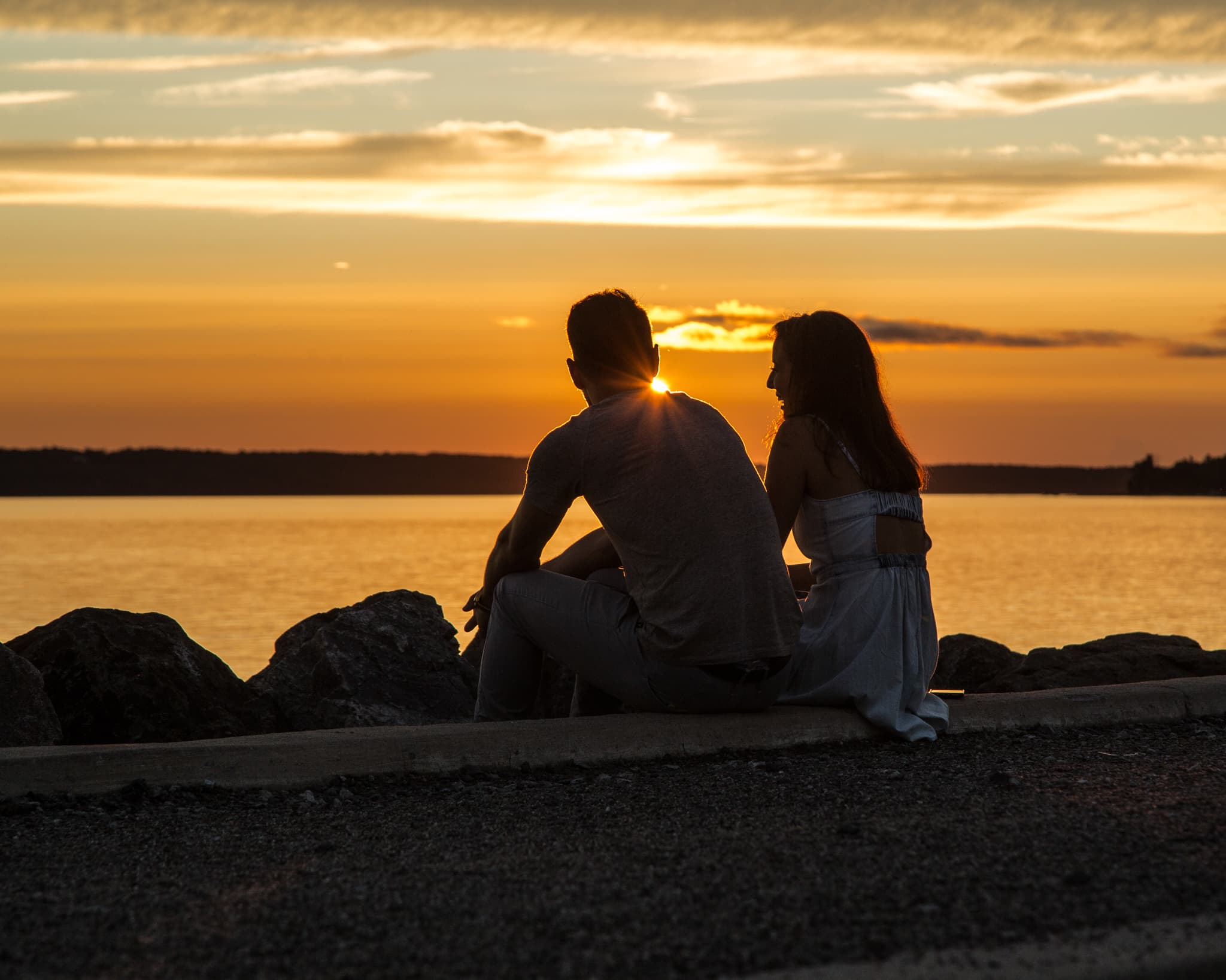 A couple watching the sunset over the Ottawa River